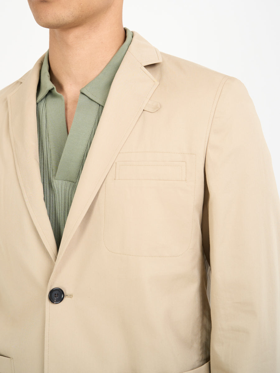Close up collar shot of model wearing Oliver Spencer Men's Unstructured Notch Lapel Beige Cotton Jacket