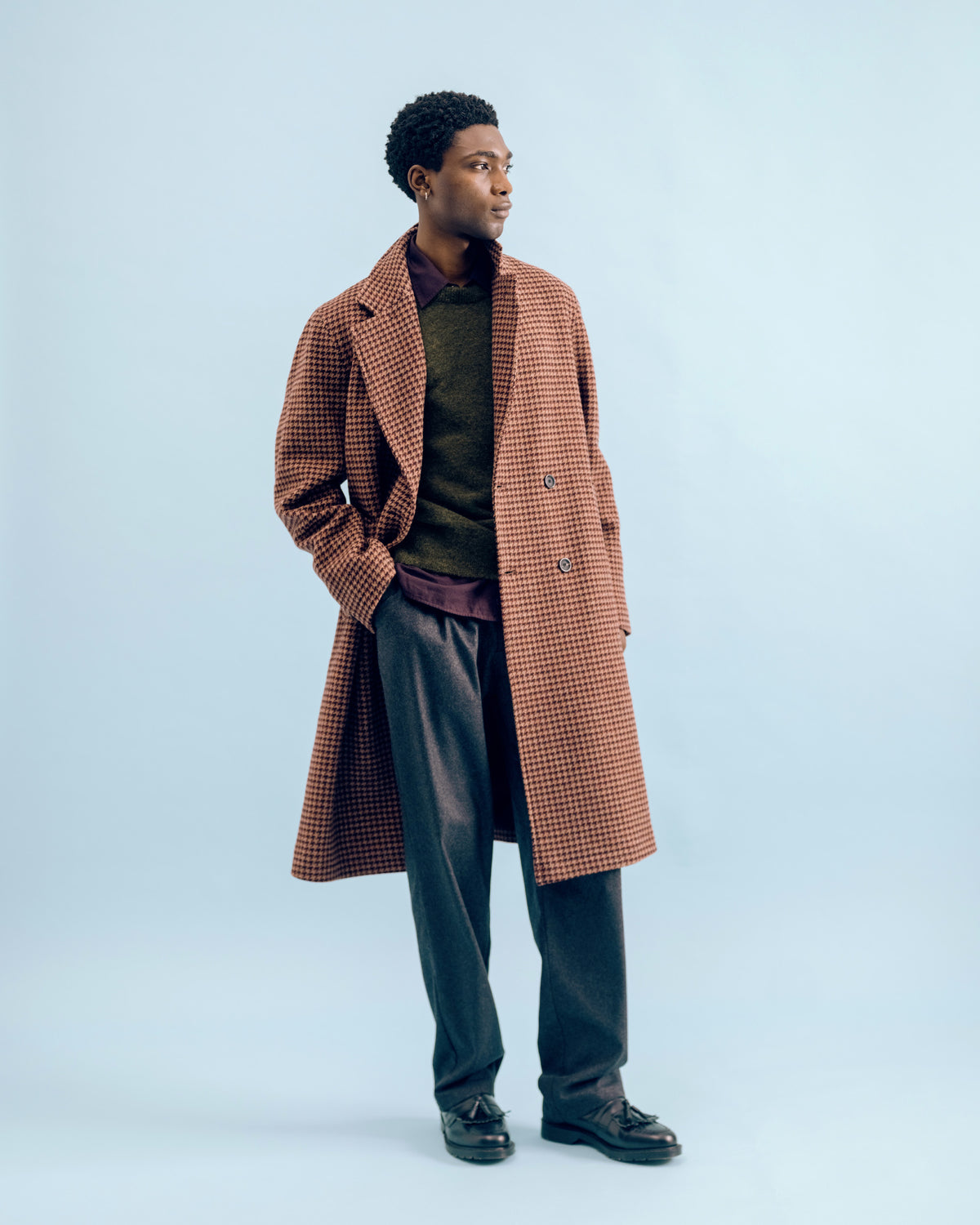 A burgundy and pink houndstooth Tamworth double breasted overcoat over a forest green Blenheim crew neck