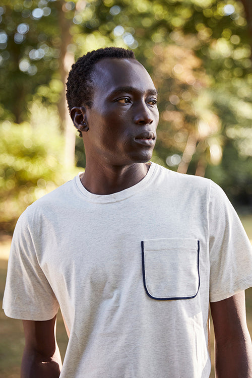 Oliver Spencer Spring 21, look 23. Portrait in a cream pocket T-shirt.
